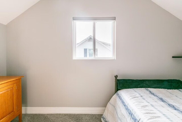 bedroom with vaulted ceiling, carpet flooring, baseboards, and visible vents