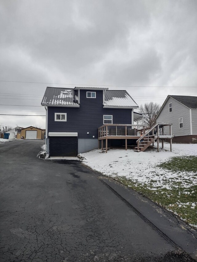 snow covered property featuring a deck and central AC