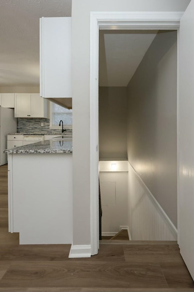 interior space featuring wainscoting and wood finished floors