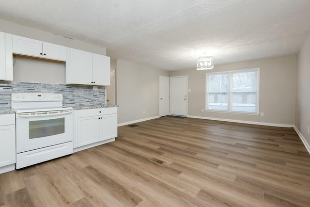 kitchen with white electric range, light wood-type flooring, backsplash, and white cabinets