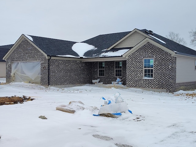 ranch-style house featuring brick siding