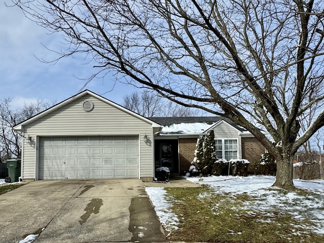 ranch-style home with driveway, brick siding, and an attached garage