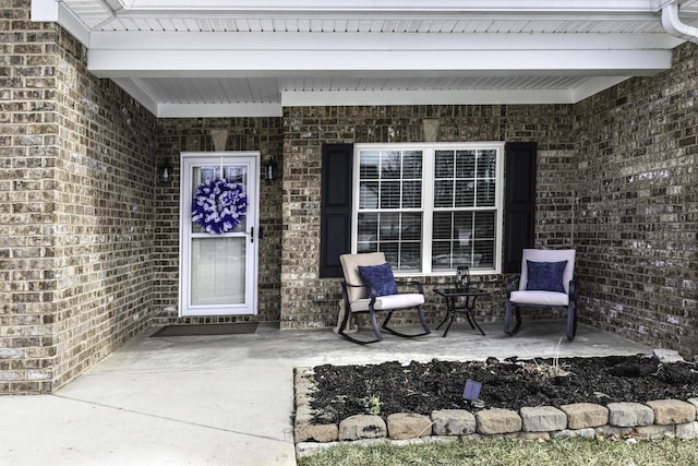 view of exterior entry featuring covered porch