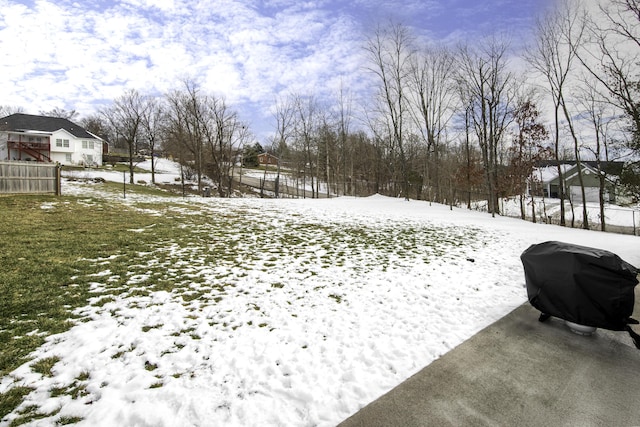 yard covered in snow with fence