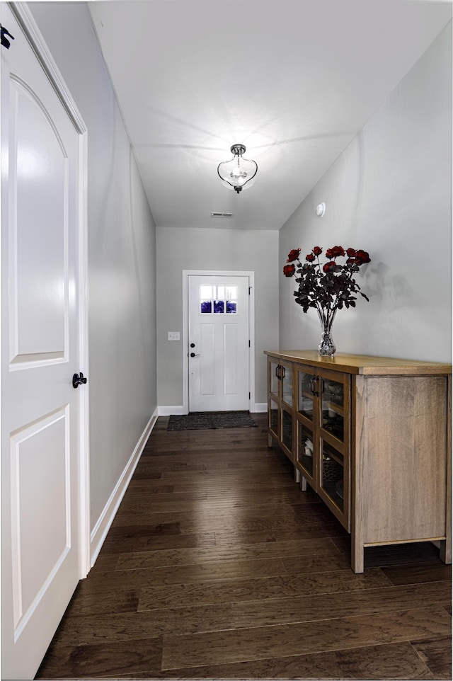 entryway featuring dark wood finished floors and baseboards