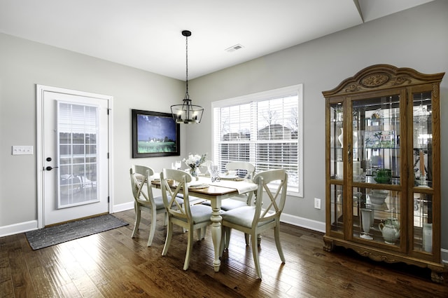 dining area with baseboards, visible vents, and dark wood-style flooring