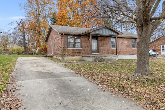 view of front of property with roof with shingles, brick siding, and crawl space