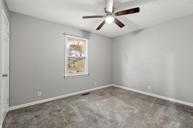 carpeted spare room with a textured ceiling, ceiling fan, visible vents, and baseboards