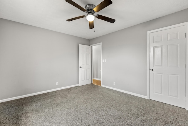 unfurnished bedroom with carpet, baseboards, and a ceiling fan