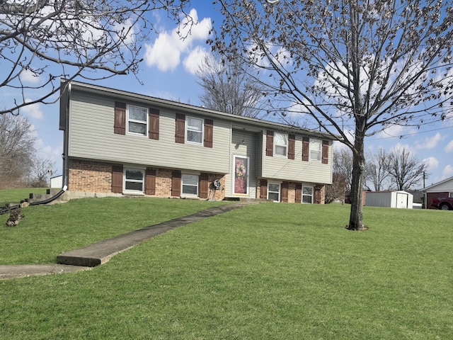 split foyer home featuring a front yard and brick siding