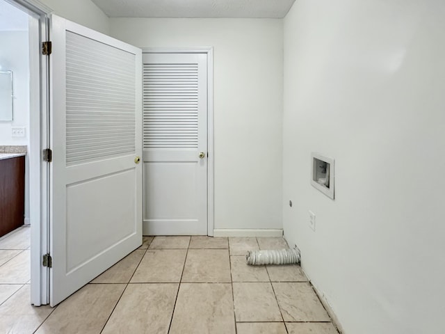 laundry room with hookup for a washing machine, light tile patterned floors, and hookup for an electric dryer