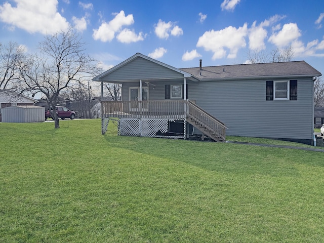 view of front facade featuring stairs, a deck, and a front yard