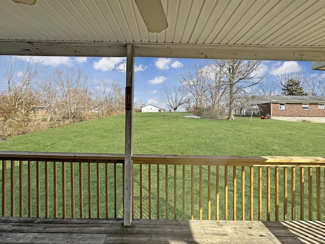 wooden deck featuring a yard