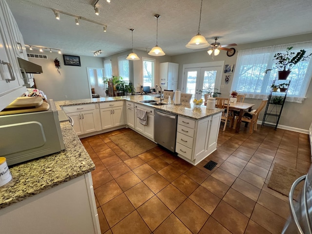 kitchen featuring dishwasher, hanging light fixtures, french doors, and white cabinetry