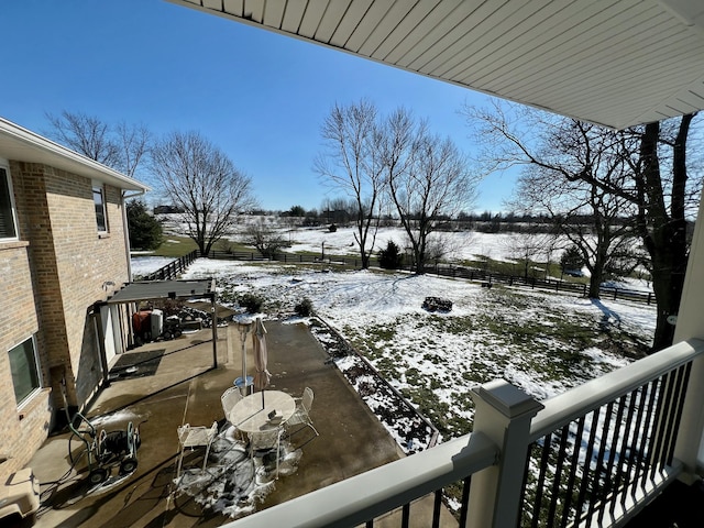 snowy yard with a patio area and a fenced backyard