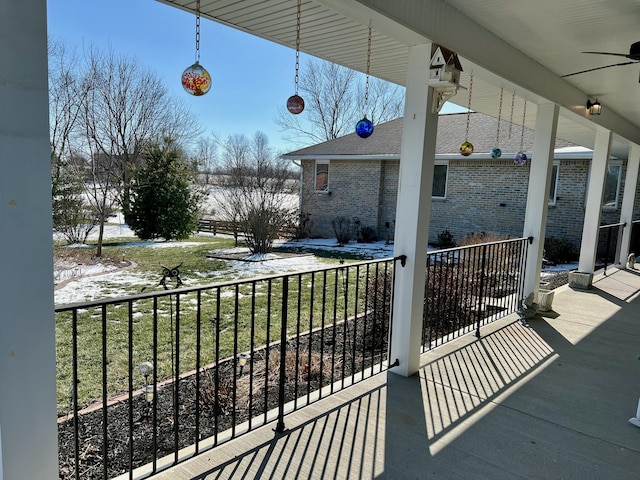 balcony featuring a porch and ceiling fan