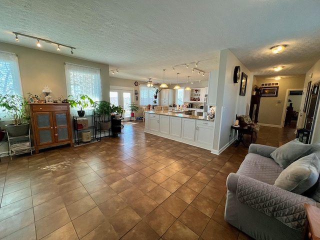 living area featuring tile patterned flooring and a textured ceiling