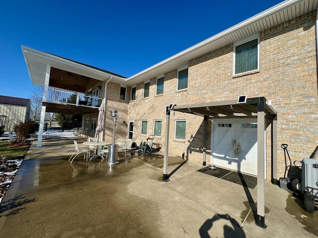 back of property featuring a patio and brick siding