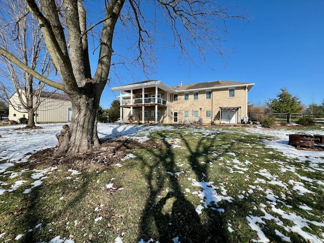 snow covered property with an attached garage and fence