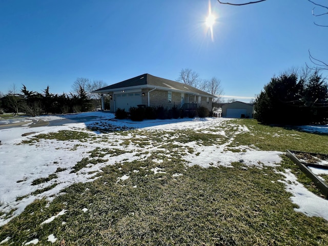 view of snowy exterior with brick siding