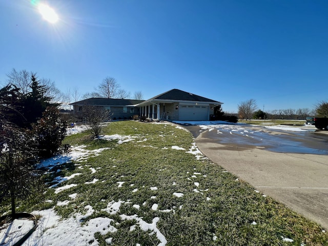 view of home's exterior featuring a garage, driveway, and a yard