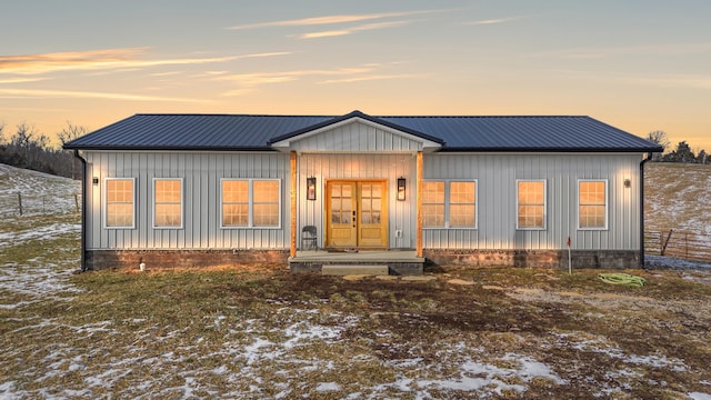 modern farmhouse style home featuring board and batten siding and metal roof