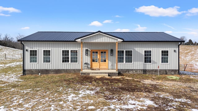 view of front of home with metal roof and board and batten siding