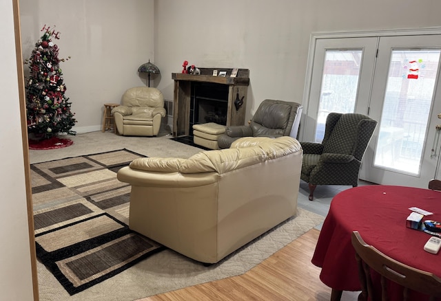 living area featuring light wood finished floors, a fireplace, and plenty of natural light