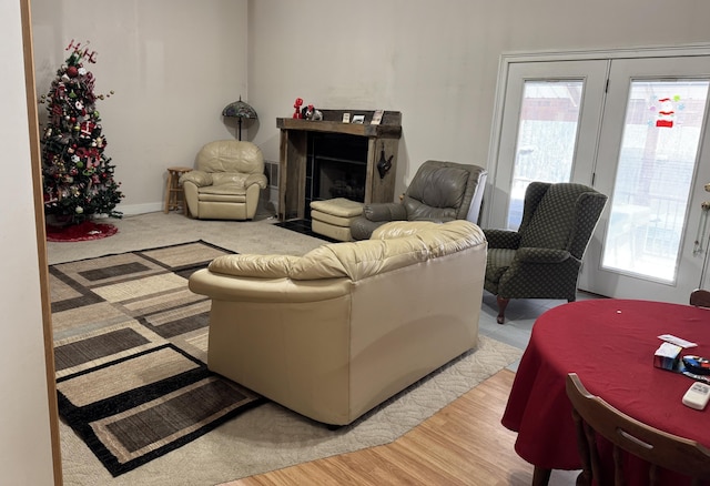 living area with light wood-type flooring, a fireplace, and baseboards