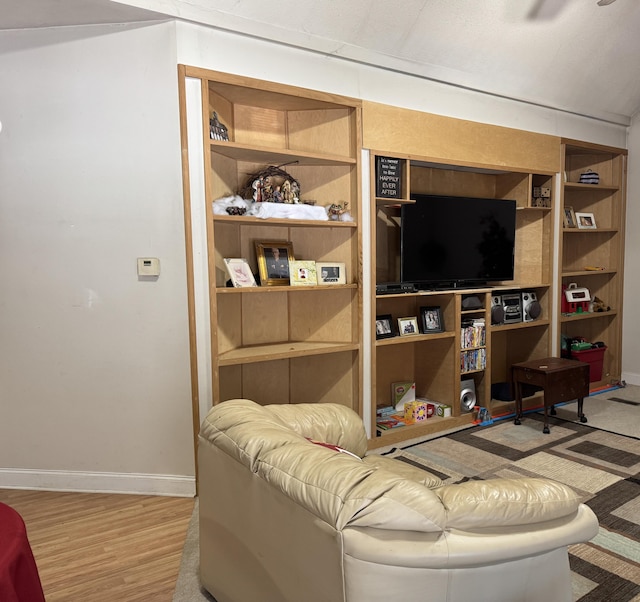 living area with light wood-style flooring and baseboards