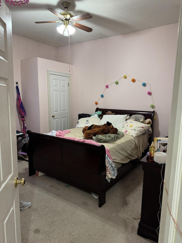 carpeted bedroom featuring a ceiling fan