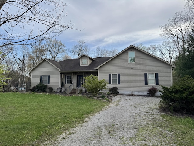 cape cod home with crawl space, driveway, and a front lawn