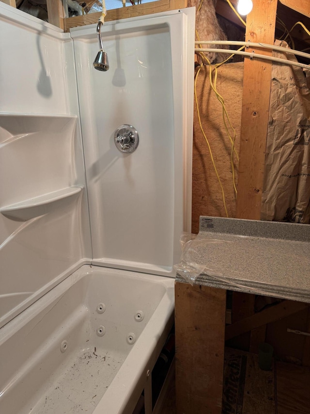 bathroom with a combined bath / shower with jetted tub