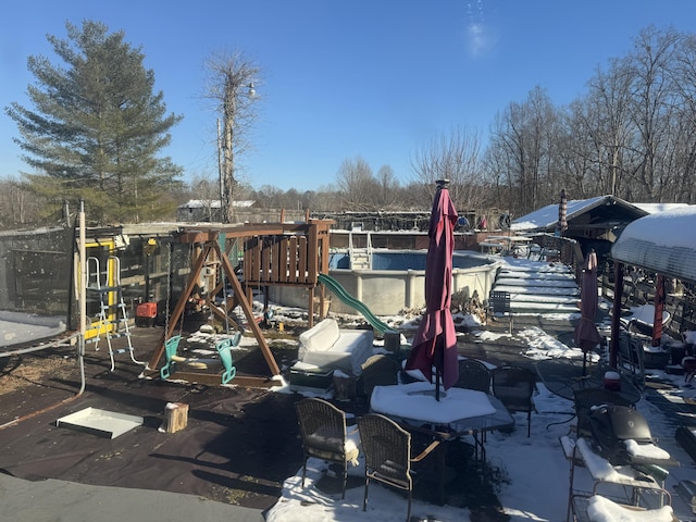 snow covered playground featuring a playground