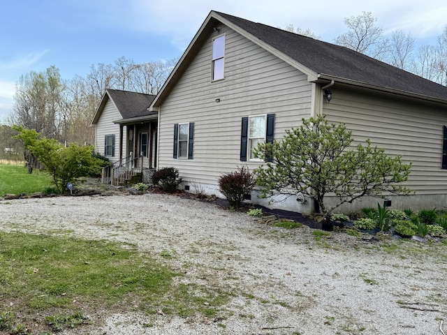 exterior space featuring roof with shingles