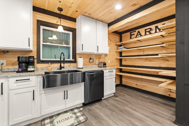 kitchen with dishwashing machine, white cabinetry, and a sink