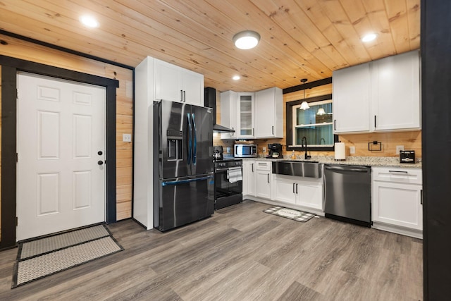 kitchen with range with electric stovetop, black refrigerator with ice dispenser, hanging light fixtures, glass insert cabinets, and dishwashing machine