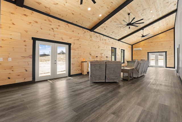 unfurnished living room with plenty of natural light, french doors, wooden ceiling, and wooden walls