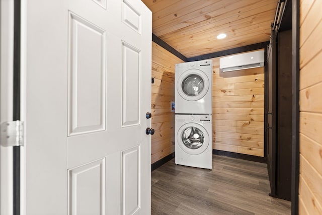 washroom featuring laundry area, wooden walls, wood ceiling, stacked washer / drying machine, and a wall mounted AC