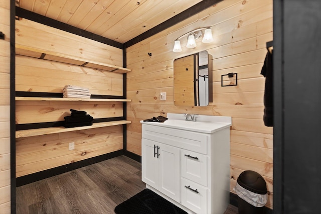 half bathroom with wood ceiling, wooden walls, wood finished floors, and vanity