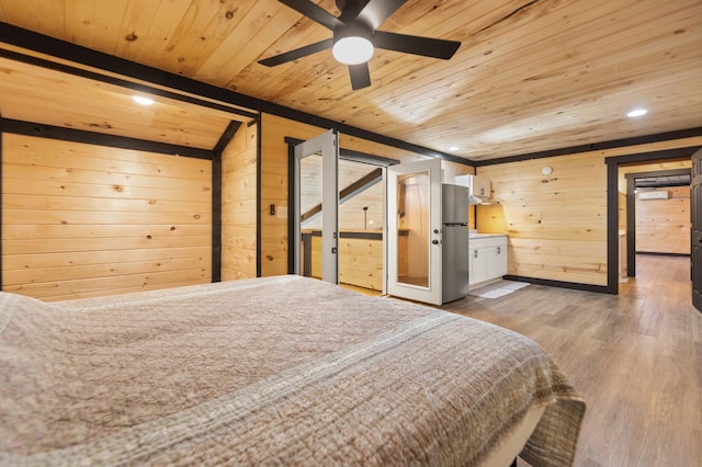 unfurnished bedroom featuring light wood-type flooring, wooden ceiling, freestanding refrigerator, and wood walls