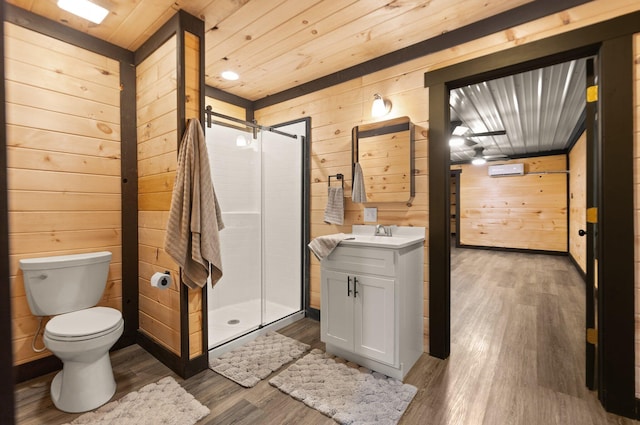 bathroom with wooden ceiling, a stall shower, wood walls, and vanity