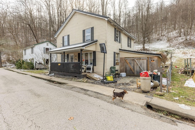 view of front of home with a porch and a garage