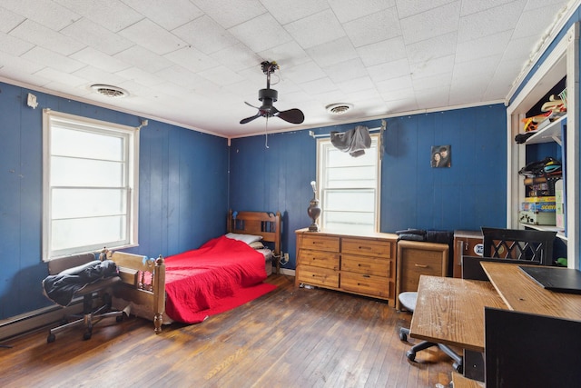 bedroom featuring ornamental molding, dark wood-style flooring, and visible vents