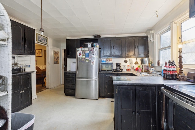 kitchen featuring range with electric cooktop, a sink, and freestanding refrigerator