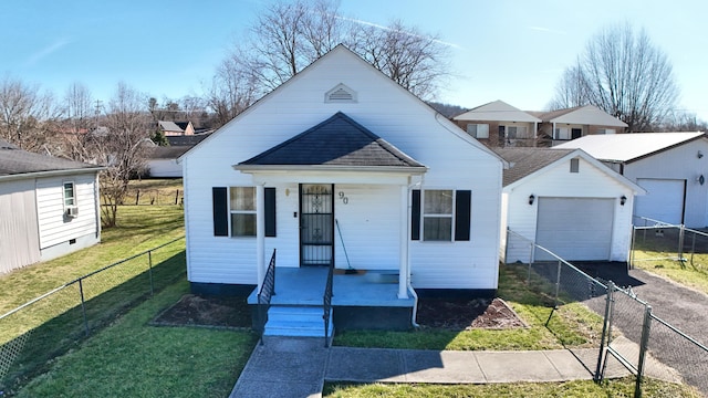 bungalow with covered porch, fence, an outdoor structure, driveway, and a front lawn