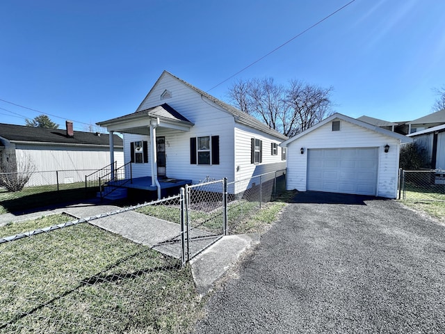 view of front of house featuring a porch, a garage, an outdoor structure, fence, and a gate