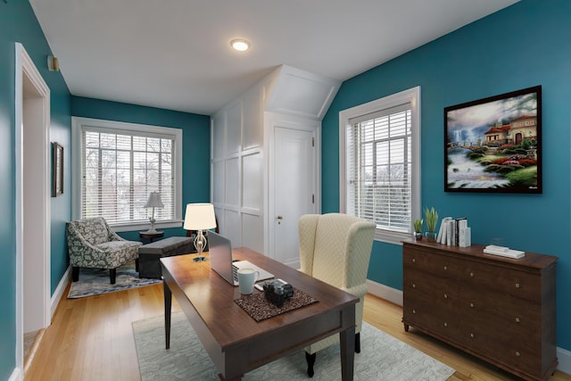 office space with plenty of natural light, light wood-style flooring, and baseboards