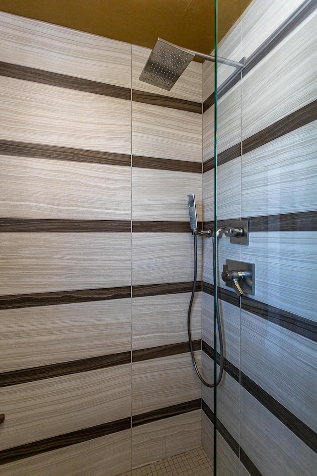 interior details featuring a tile shower