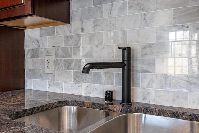 room details with dark stone counters and a sink